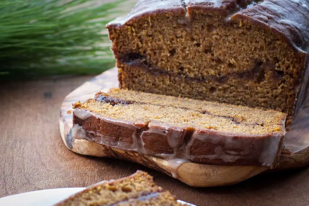 pumpkin banana bread loaf with a slice cut off showing the cinnamon swirl inside