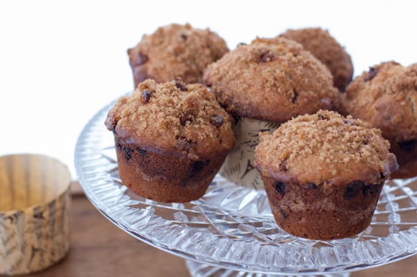 Clear crystal cake plate loaded with lots of cinnamon muffins