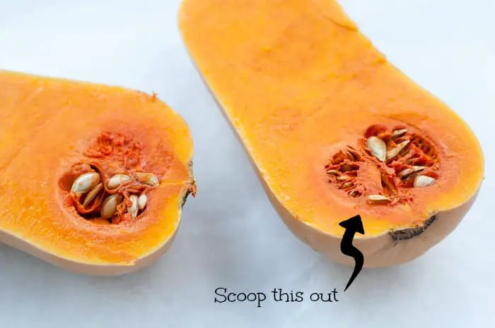 Butternut squash cut in half with the seeds still in