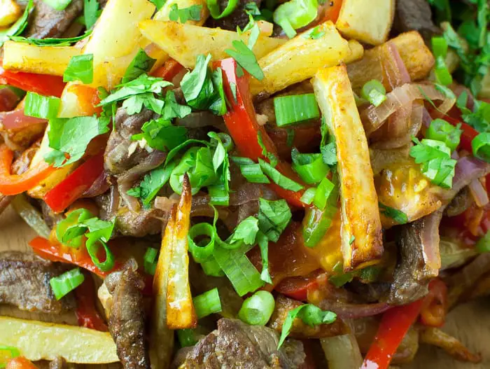 Lomo Saltado - a Peruvian beef stir-fry with bold flavors. Top with Peruvian Green Sauce or Salsa Criolla - one of my favorite dishes from El Pollo Inka