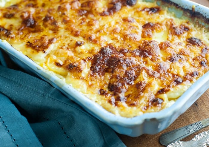 Cheesy Scalloped Potatoes Au Gratin with Gruyere and Fontina - has a hint of garlic and Parmesan cheese. The BEST casserole for a great side dish!