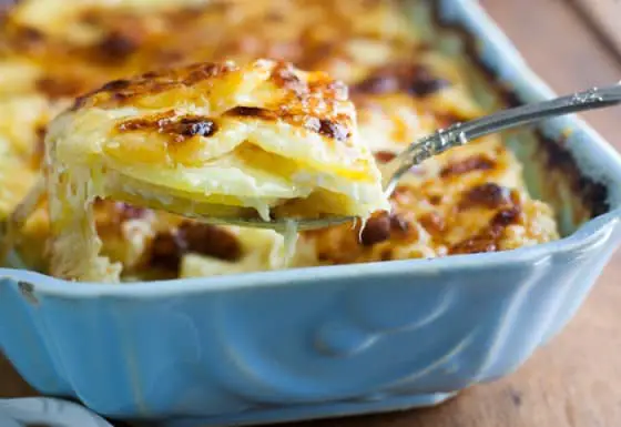 Cheesy Scalloped Potatoes Au Gratin with Gruyere and Fontina - has a hint of garlic and Parmesan cheese. The BEST casserole for a great side dish!