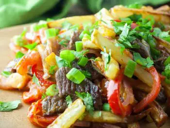 Lomo Saltado - a Peruvian beef stir-fry with bold flavors. Top with Peruvian Green Sauce or Salsa Criolla - one of my favorite dishes from El Pollo Inka