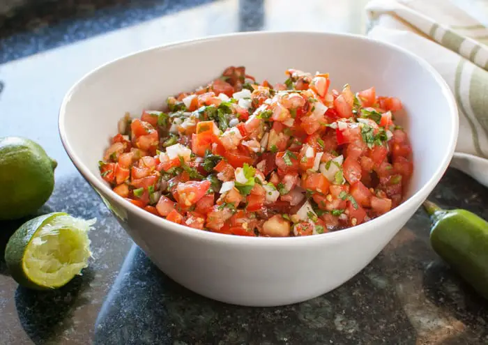 Pico de Gallo (Salsa Fresca) recipe is a perfect topping to many dishes. Make it mild or spicy!