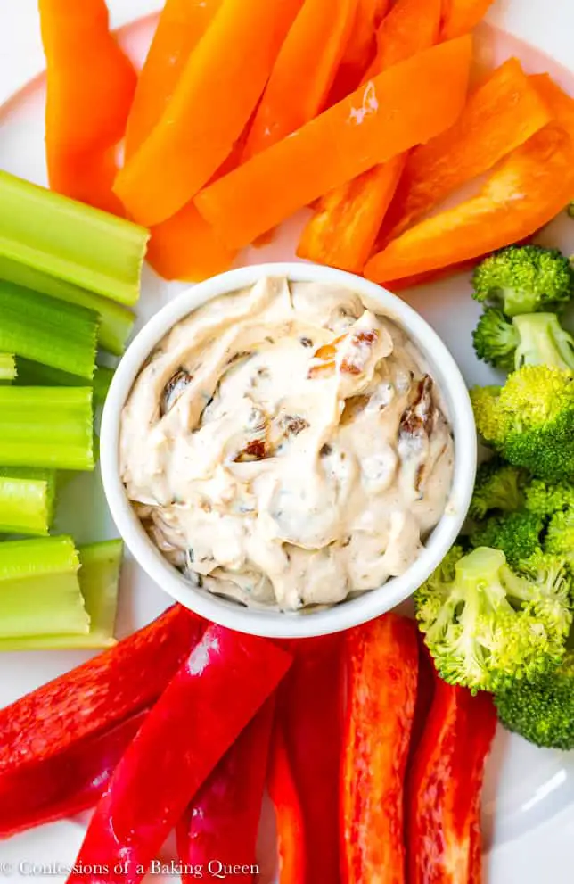 Bowl with French onion dip loaded with real onions in the center of colorful cut vegetables