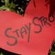 Cut out red paper hard that says Stay Strong