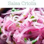 Closeup of sliced marinated red onions with bits of cilantro with test Peruvian-Style Salsa Criolla